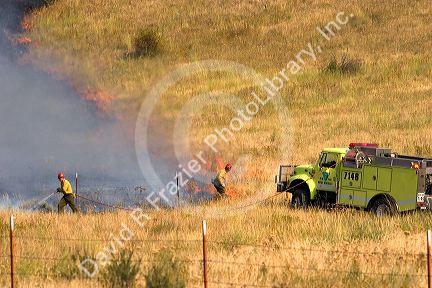 Firefighters work to controll a fire in the Boise foothills, Idaho.