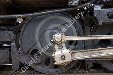 Close up detail view of a steam locomotive drive wheel.
