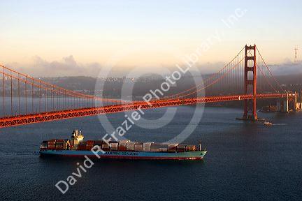 A container ship passes under the Golden Gate Bridge in the San Francisco Bay, California.
