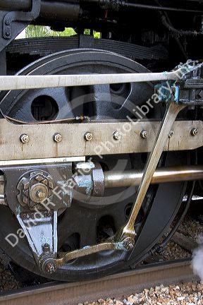 Close up detail view of steam locomotive drive wheel.