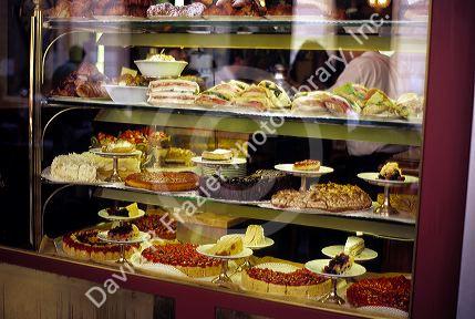 A restaurant display widow showing pastries and sandwiches in Italy.