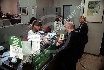 Tellers and customers inside of a bank in Turino, Italy.