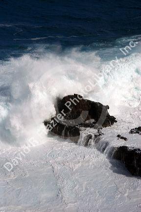 Waves crash in the pacific ocean off the island of Maui, Hawaii.