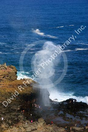 Waves crash through a blow hole on the island of Maui, Hawaii.