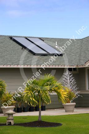 Solar pannels atop the roof of a modern housing developement on the island of Maui, Hawaii.