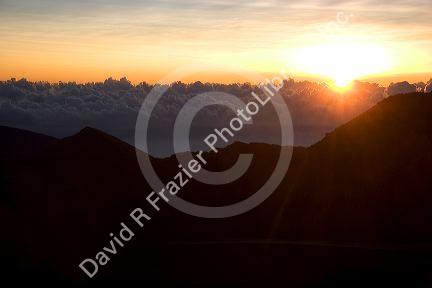 Sunrise above the clouds atop Mount Haleakala on the island of Maui, Hawaii.