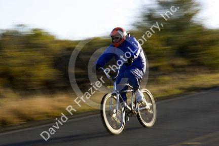 Tourists ride bicycles down Mount Haleakala on the island of Maui, Hawaii.