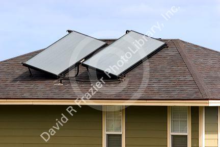 Solar pannels atop the roof of a modern housing developement on the island of Maui, Hawaii.