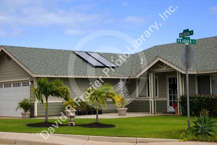 Solar pannels atop the roof of a modern housing developement on the island of Maui, Hawaii.