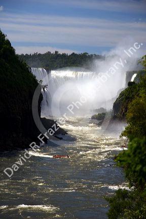 Tour boat beneath waterfalls at Iguazu, Argentina.