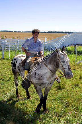 Gaucho cowboys on horseback near Neccochea, Argentina.
