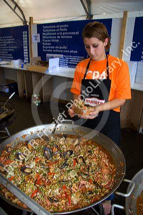 Worker serves a seafood dish of paella at Mar del Plata, Argentina.