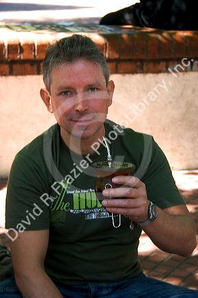 Street vendor drinking mate at Plaza Derrego in Buenos Aires, Argentina.