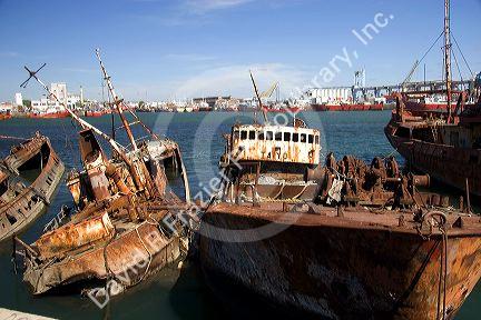 Junk fishing boats rust in the water at Puerto Faro, Mar del Plata, Argentina.