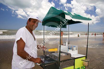 Vendor selling ears of corn on the beach at Pinamar, Argentina.
