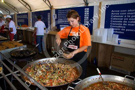 Worker serves a seafood dish of paella at Mar del Plata, Argentina.