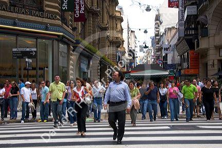 Pedestrians crossing Avenida Cordoba on the walking street Avenida Florida  in Buenos Aires, Argentina.