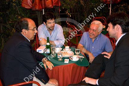 Argentine men having a conversation at a  restaurant in Buenos Aires, Argentina.