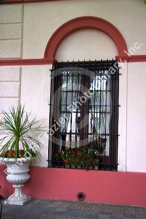 Window with flowers on a building in Colonia, Uraguay.
