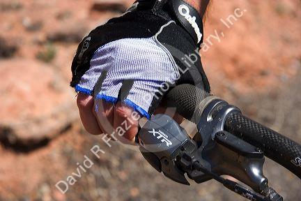Mountain biking in the desert near Moab, Utah.  Detail of fingerless glove and handbrake.  (Model released)