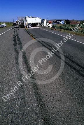 Traffic accident and skid marks from tires on the highway.