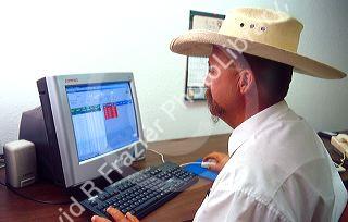 Cowboy business man working on his computer.