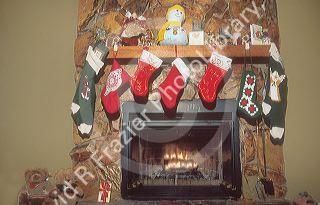 Christmas stockings hung on mantle of fireplace.