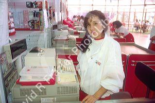 Young Chilean woman at work in a supermarket.  Santiago, Chile.