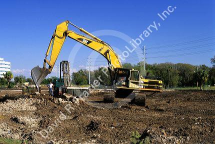 Tracked power shovel being used to clear land for a construction site in Florida.