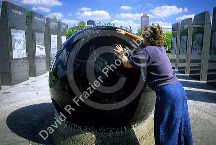 A woman rolling a floating granite ball at the Capitol Mall in Nashville, Tennessee.
