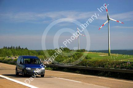 Electricity wind generators and automobiles traveling on the highway in northwest Germany.