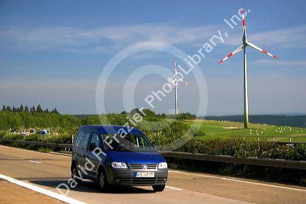 Electricity wind generators and automobiles traveling on the highway in northwest Germany.