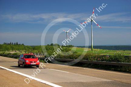 Electricity wind generators and automobiles traveling on the highway in northwest Germany.