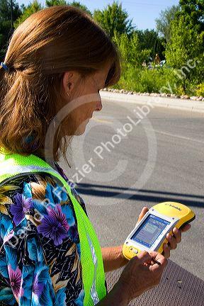 A woman using a handheld GIS device in the field, Boise, Idaho.