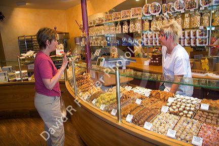 Woman purchasing cookies at a bakery in Strasbourg, France.