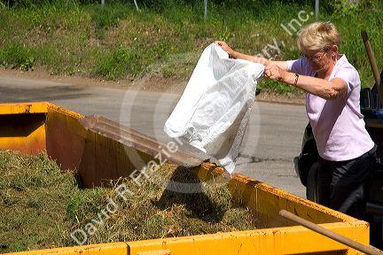 A woman recycling yard waste at Gerardmer, France.
