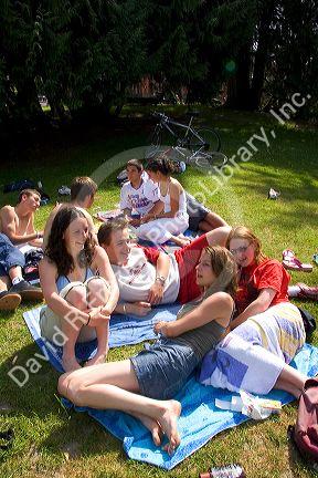 Teens hang out on the banks of Lake Gerardmer, France.