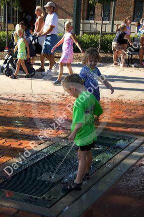 Children play in a fountain at the Iowa state fair in Des Moines.