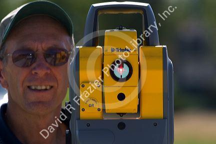 Surveyor using a laser transit in Boise, Idaho.