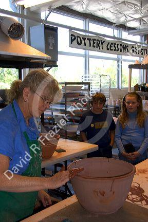 Children watch an artist making clay pots at the Foundry Art Centre in St. Charles, Missouri.