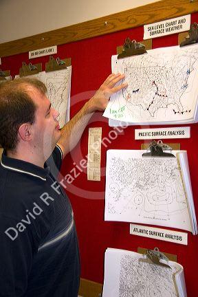 A student looking at maps in the Missouri Climate Center at the University of Missouri - Columbia.