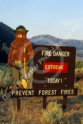 A forest service sign with Smokey Bear warning of extreme fire danger in Idaho.