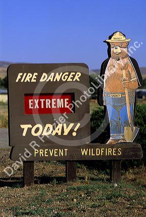A forest service sign with Smokey Bear warning of extreme fire danger in Idaho.