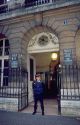 Policeman stands guard in front of the entrance to court in Paris, France.