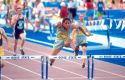 Male high school student competeing in a hurdles track event. Boise, Idaho.
