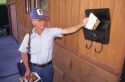 A postal worker delivering mail.