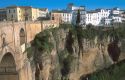 The gorge in Ronda, Spain with buildings on the edge and a view of the bridge.