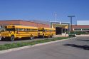 School buses parked in front of an elementary school.
