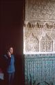 Female tourist listens to tour translation at Alcazar in Seville, Spain.