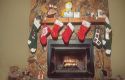 Christmas stockings hung on mantle of fireplace.